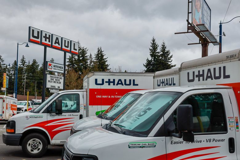 Vans await renting Friday afternoon at the U-Haul rental store on Aurora Avenue in Shoreline on Friday. A new survey shows about 171,600 households in the Seattle area in 2021 were either thinking about or planning to move to another location in the next 12 months. (Kevin Clark / The Seattle Times)