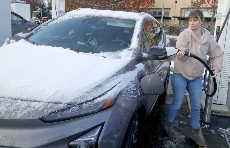 Naomi Johnson prepares to charge her Chevrolet Volt EV at the EV Go Charging station on NE Northgate Way. Asked if thereâ€™s a difference in the battery lasting between summer and winter, she said â€œIt sucks!. She said she gets about 30% less mileage in the colder months. 222531
