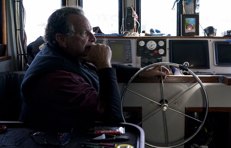 Bob Maharry sits inside his fishing boat docked at Pier 45 in San Francisco, Monday, March 20, 2023. This would usually be a busy time of year for Maharry and his crew as salmon fishing season approaches. On April 7, the Pacific Fishery Management Council, the regulatory group that advises federal officials, will take action on what to do about the 2023 season for both commercial and recreational salmon fishing. (AP Photo/Godofredo A. Vásquez) CAGV307 CAGV307