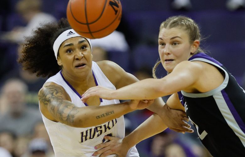 Washington Huskies guard Jayda Noble pokes the ball away from Kansas State guard Gabby Gregory during the second quarter. (Jennifer Buchanan / The Seattle Times)