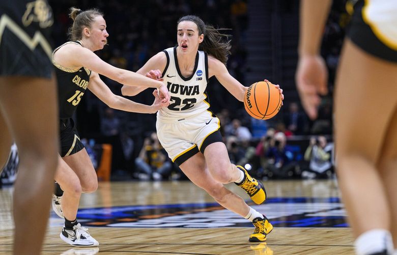Iowa’s Caitlin Clark drives as Colorado’s Kindyll Wetta defends during the first quarter of a Sweet 16 college basketball game in the women’s NCAA Tournament in Seattle, Friday, March 24, 2023. (AP Photo/Caean Couto) WACC101 WACC101