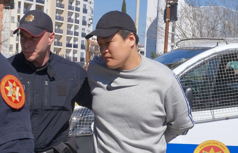 Montenegrin police officers escort an individual who is believed to be one of the most wanted fugitives, South Korean citizen, Terraform Labs founder Do Kwon in Montenegro’s capital Podgorica, Friday, March 24, 2023. South Korea’s Justice Ministry on Friday confirmed the arrest of Kwon and another unidentified individual linked to the cryptocurrency crash and said it will proceed with steps to extradite them to South Korea. Both South Korea and Montenegro are signees to the European Convention on Extradition. (AP Photo/Risto Bozovic) 