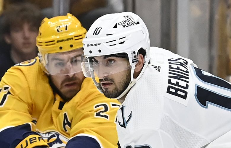 Seattle Kraken center Matty Beniers (10) maneuvers the puck between Nashville Predators’ Dante Fabbro (57) and Ryan McDonagh (27) during the third period of an NHL hockey game Saturday, March 25, 2023, in Nashville, Tenn. The Kraken won 7-2. (AP Photo/Mark Zaleski) TNMZ118 TNMZ118