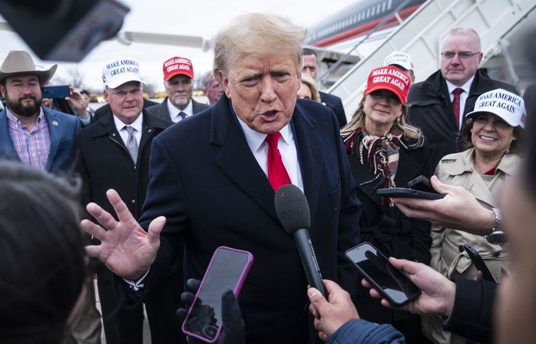 Former president Donald Trump speaks with reporters as he lands at Quad City International Airport on March 13 in Moline, Ill. MUST CREDIT: Washington Post photo by Jabin Botsford