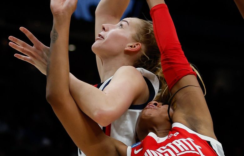 UConn forward Dorka Juhasz gets past Ohio State forward Cotie McMahon for a lay-up during the third quarter. 223352