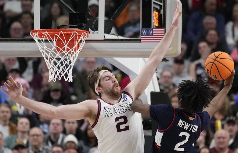 UConn guard Tristen Newton (2) shoots while defended by Gonzaga forward Drew Timme (2) in the first half of an Elite 8 college basketball game in the West Region final of the NCAA Tournament, Saturday, March 25, 2023, in Las Vegas. (AP Photo/John Locher) NVAP126 NVAP126