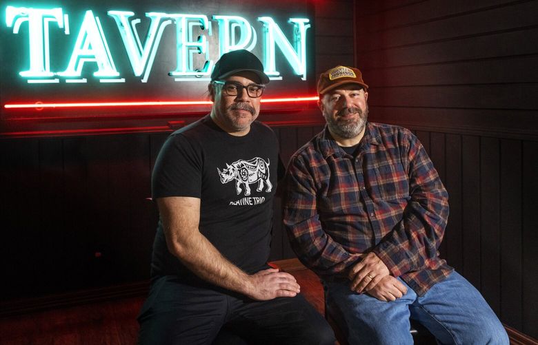 Tim’s Tavern owners Mason Reed (l) and Matt O’Toole sit in front of their neon sign hanging at the Seattle Legends stage in their new neighborhood bar/music venue, Tim’s Tavern located in White Center Thursday, March 23, 2023.  .

After closing its Greenwood spot in 2021, Tim’s Tavern has found a new home in White Center, taking over a former Drunky’s BBQ location. They’re keeping the outdoor stage and Airstream trailer bar where they will have live music and dogs are welcome. 223372