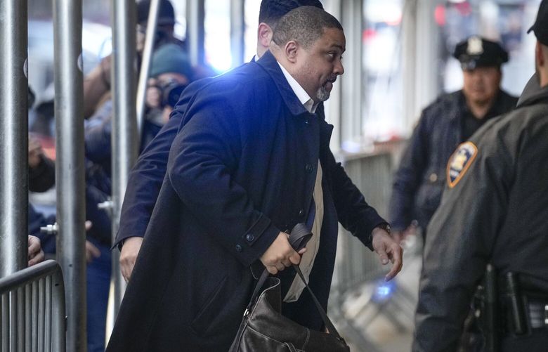 Surrounded by security, Manhattan District Attorney Alvin Bragg arrives to his office in New York, Monday, March 27, 2023. (AP Photo/Seth Wenig) NYSW102 NYSW102