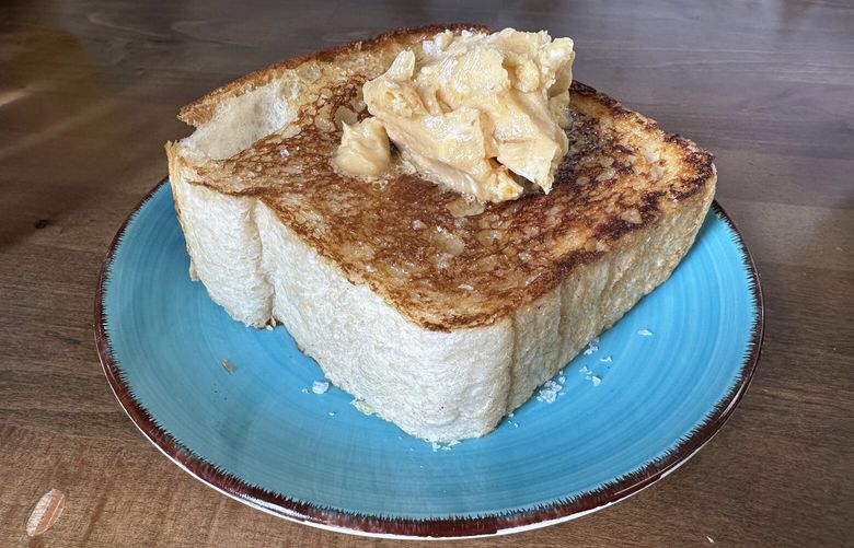 The honeycomb toast at Martini Brunch in Mount Vernon is a wonderfully thick cut of toast topped with a scoop of delectable honey butter. Order one for the table. (Jackie Varriano / The Seattle Times)
