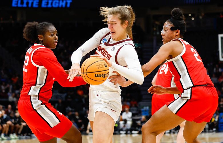 Virginia Tech’s Elizabeth Kitley fights off the double team down low by Ohio State’s Eboni Walker, left, and Taylor Thierry in the first half. 223354