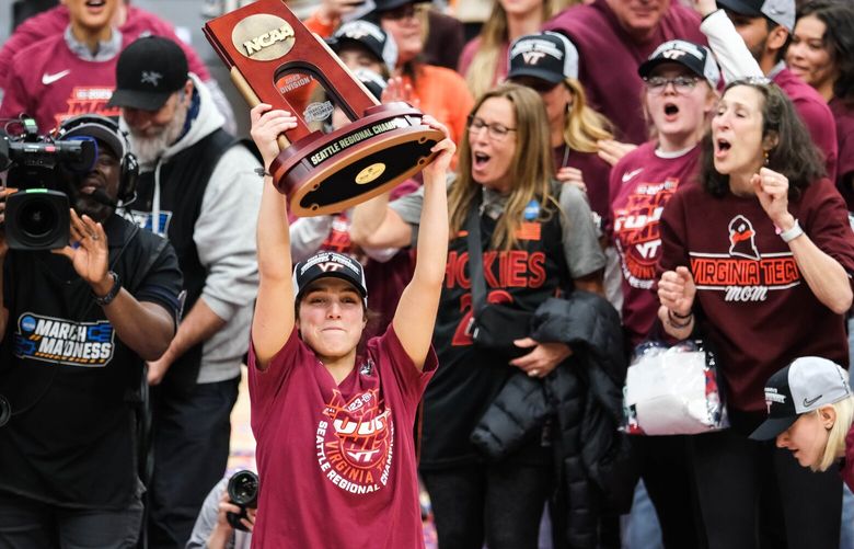 Virginia Tech guard Georgia Amoore raises the Regional Championship Trophy won over Ohio State Monday at Climate Pledge Arena. 223354