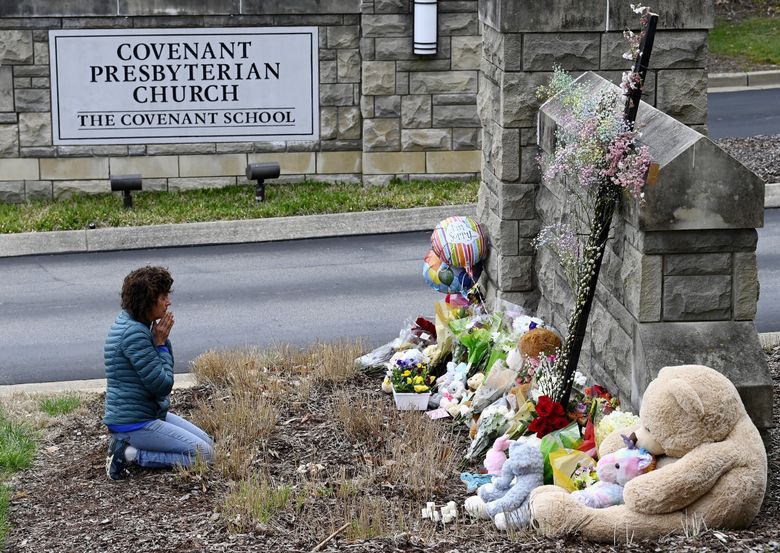 Robin Wolfeden prays in front of a makeshift memorial at the entrance to The Covenant School Tuesday, March 28, 2023, in Nashville, Tenn. Three children and three school staff members were killed by a former student in Monday’s mass shooting. (Mark Zaleski /The Tennessean via AP) TNNAT101 TNNAT101 (Mark Zaleski / The Associated Press)