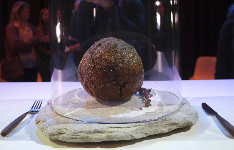 A meatball made using genetic code from the mammoth is seen at the Nemo science museum in Amsterdam, Tuesday March 28, 2023. An Australian company has lifted the glass cloche on a meatball made of lab-grown cultured meat using the genetic sequence from the long-extinct mastodon. The high-tech treat isn’t available to eat yet – the startup says it is meant to fire up public debate about cultivated meat. (AP Photo/Mike Corder) LON501 LON501