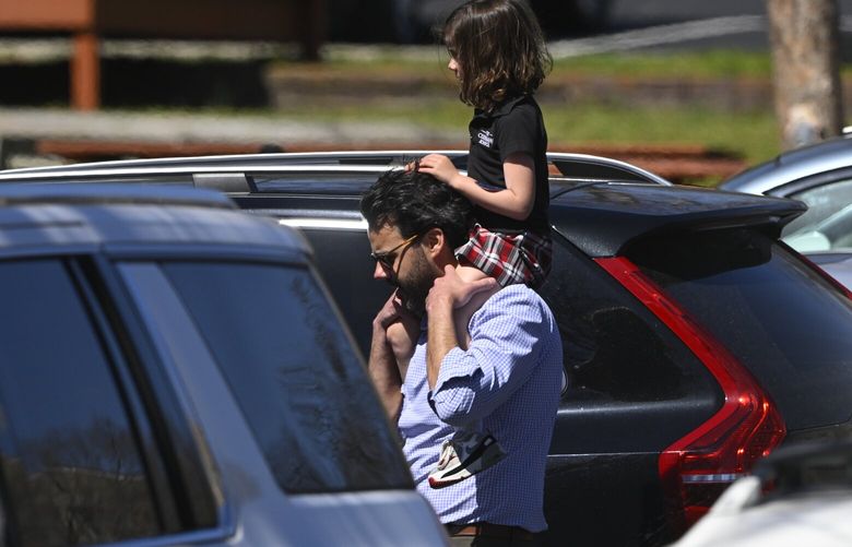 A family leave a reunification site in Nashville, Tenn., Monday, March 27, 2023 after several children were killed in a shooting at Covenant School in Nashville. The suspect is dead after a confrontation with police. (AP Photo/John Amis) ILKS111 ILKS111