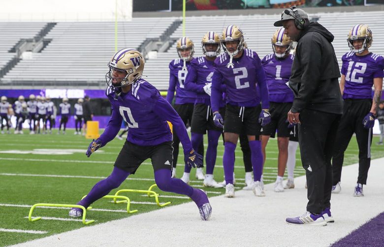 Wide receiver, Giles Jackson, runs through an agility drill during spring practice Wednesday morning at Husky Stadium in Seattle, Washington on March 8, 2023.
