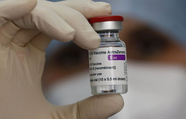 A health worker holds up a dose of the AstraZeneca vaccine against COVID-19 to be administered to members of the Italian Army at a vaccination center set up at the military barracks of Cecchignola, in Rome, Tuesday, Feb. 23, 2020.  (Cecilia Fabiano/LaPresse via AP) ROM805