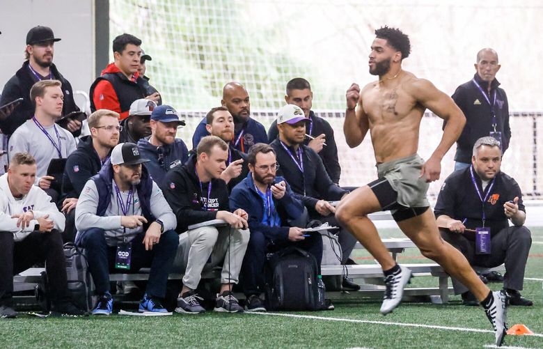 Alex Cook crosses the finish line in the 40-yard dash Wednesday afternoon during Pro Day in the Dempsey Indoor Center at the University of Washington in Seattle, Washington on March 29, 2023.