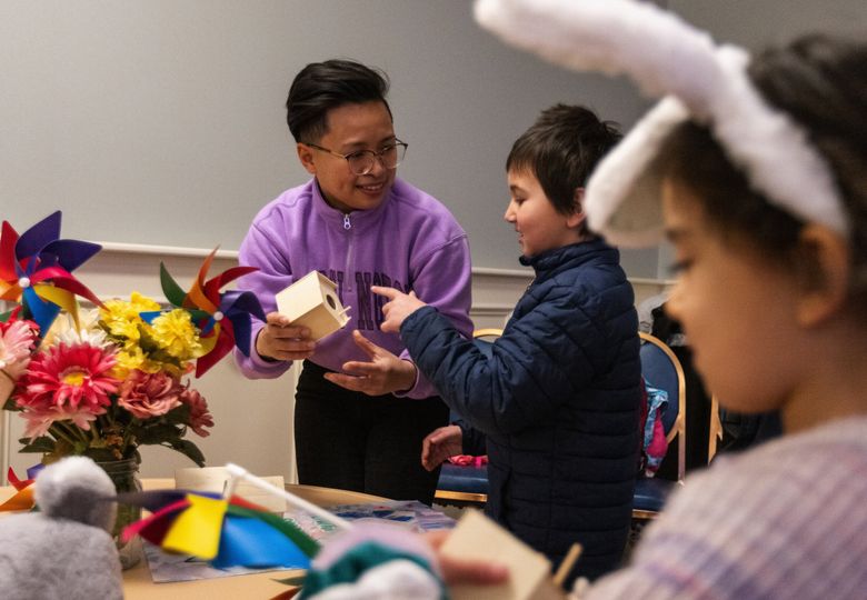 Jemina Marasigan, who recently completed an early childhood education degree from the University of Washington, talks with 7-year-old Sanjay about an art project at University Gathering United Methodist Church on Sunday in Seattle. (Ken Lambert / The Seattle Times)