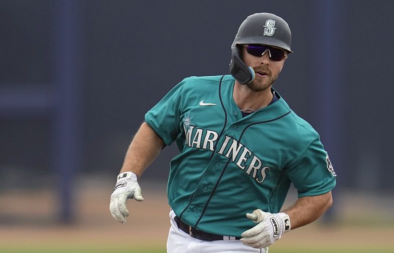 Seattle Mariners’ Cooper Hummel runs the bases after hitting a solo home run during the third inning of a spring training baseball game against the Milwaukee Brewers, Monday, March 20, 2023, in Peoria, Ariz. (AP Photo/Abbie Parr)