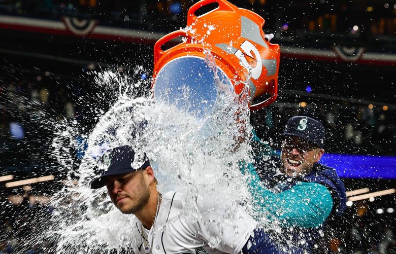 Ty France gets doused with the Gatorade bucket after his 3-run homer won it for Seattle in the eighth. 223386