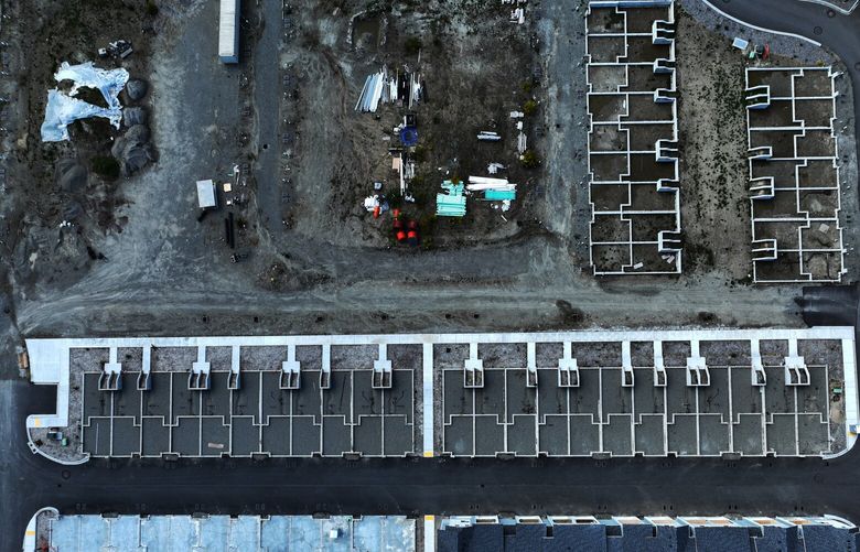 Empty lots mixed in with a stretch of built homes are visible from this aerial view of the construction zone at the Seaside Townhomes development in Kingston on May 19, 2022.