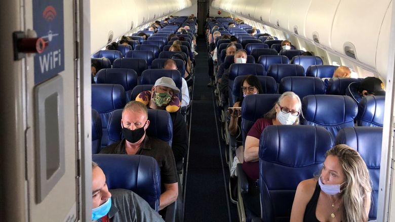 Masked passengers fill a Southwest Airlines flight from Burbank to Las Vegas on June 3, with middle seats left open. (Christopher Reynolds/Los Angeles Times/TNS)