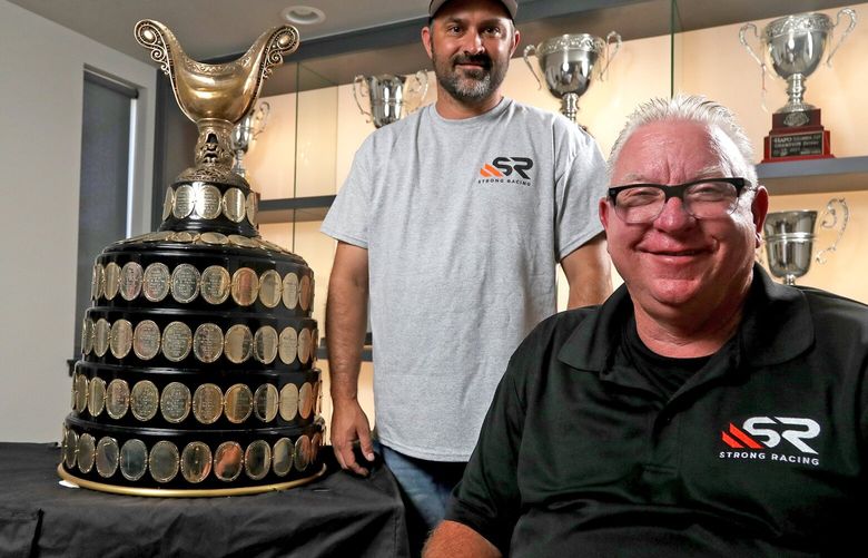 Strong racing owner Darrell Strong with his driver Cory Peabody, left, with the coveted Gold Cup they won June 26 this year at the Guntersville, Alabama race. 220984