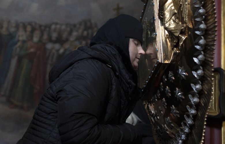 A woman kisses an icon as she prays in the Kyiv Pechersk Lavra monastery complex in Kyiv, Ukraine, Wednesday, March 29, 2023. The Russian invasion of Ukraine is reverberating in a struggle for control of a monastery complex. The government says it’s evicting the Ukrainian Orthodox Church from the complex as of March 29, accusing it of pro-Russia actions and ideology. (AP Photo/Andrew Kravchenko) XEL110 XEL110
