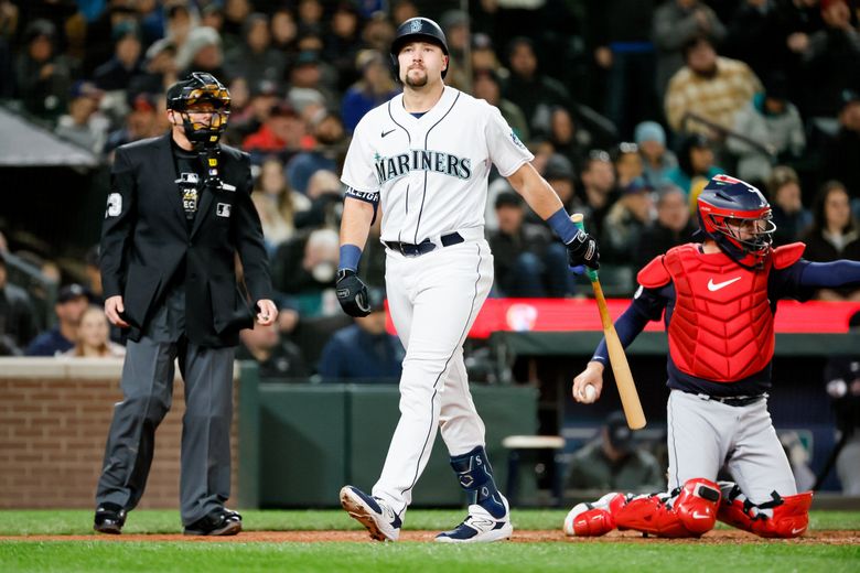Seattle Mariners pinch hitter Cal Raleigh heads back to the dugout after getting called out on strikes during the eighth inning Saturday. (Jennifer Buchanan / The Seattle Times)