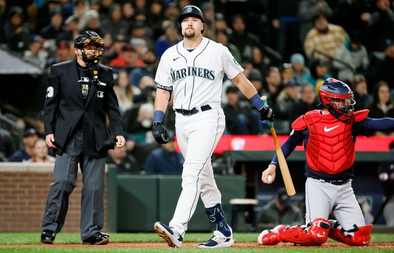 Seattle Mariners pinch hitter Cal Raleigh heads back to the dugout after getting called out on strikes during the eighth inning. 223388