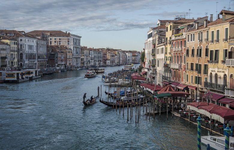 The Grand Canal in Venice, Italy on Nov. 20, 2022. Since its first inhabitants built foundations with wooden piles in the sediment in the fifth century, water has both protected and threatened Venice. (Laetitia Vancon/The New York Times) XNYT12 XNYT12