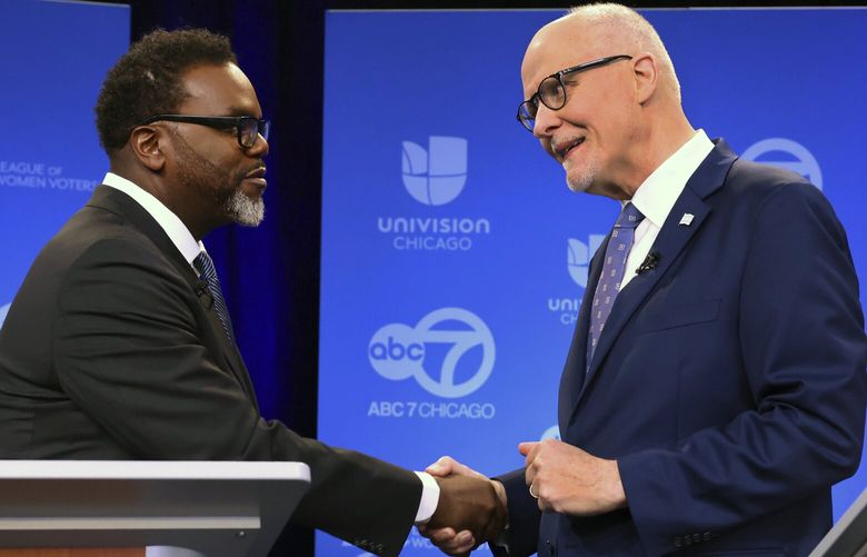 Chicago mayoral candidates Brandon Johnson, left, and Paul Vallas shake hands before the start of a debate at ABC7 studios in downtown Chicago, Thursday, March 16, 2023. (Chris Sweda/Chicago Tribune via AP, Pool) ILCHT401 ILCHT401
