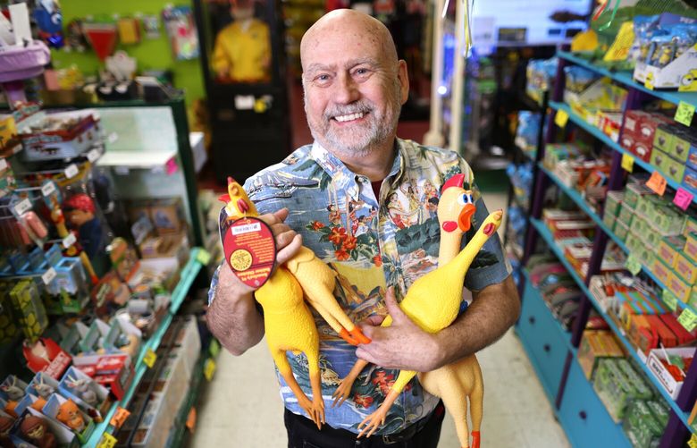 Owner of Archie McPhee, Mark Pahlow, poses for a photo while holding rubber ducks in the Wallingford store location in Seattle on Thursday, March 23, 2023. Archie McPhee has been in business for 40 years.