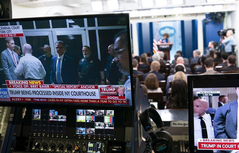 Monitors broadcast news about the arraignment of former President Donald Trump during a press briefing with Press Secretary Karine Jean-Pierre at the White House in Washington, April 4, 2023. Democrats and other critics of former President Donald Trump greeted the spectacle of his arrest on Tuesday, April 4, 2023, with a blend of gleeful schadenfreude and far more muted initial reactions. (Sarah Silbiger/The New York Times)