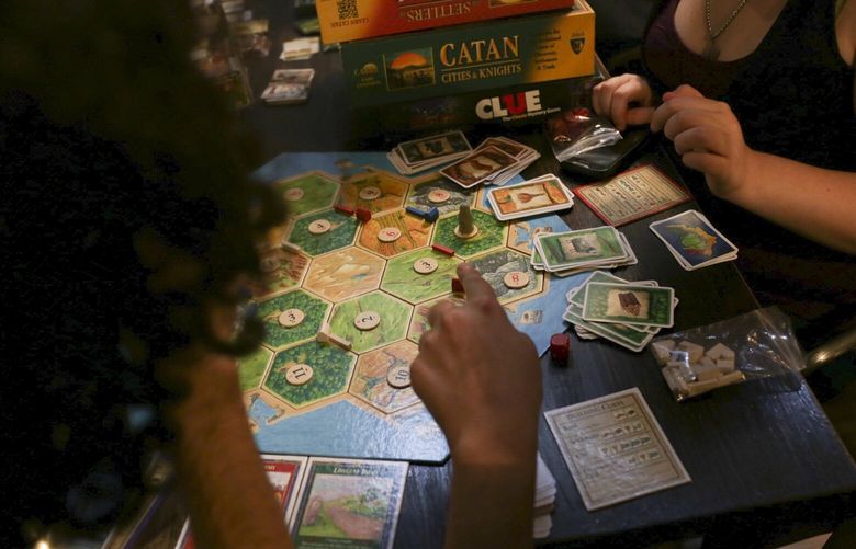 FILE — Patrons play a game of The Settlers of Catan at The Uncommons board game cafe in New York, July 30, 2014. Klaus Teuber, who 28 years ago created The Settlers of Catan, an enduringly popular board game that has spawned college intramural teams and international tournaments, been name-checked on “South Park” and “Parks and Recreation,” inspired a novel and sold some 40 million copies worldwide, died on Saturday. He was 70. (Jake Naughton/The New York Times) XNYT61 XNYT61