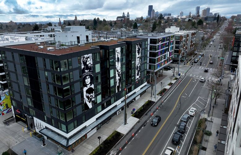 A car drives past the Midtown Square building during a cloudy day on March 23, 2022.