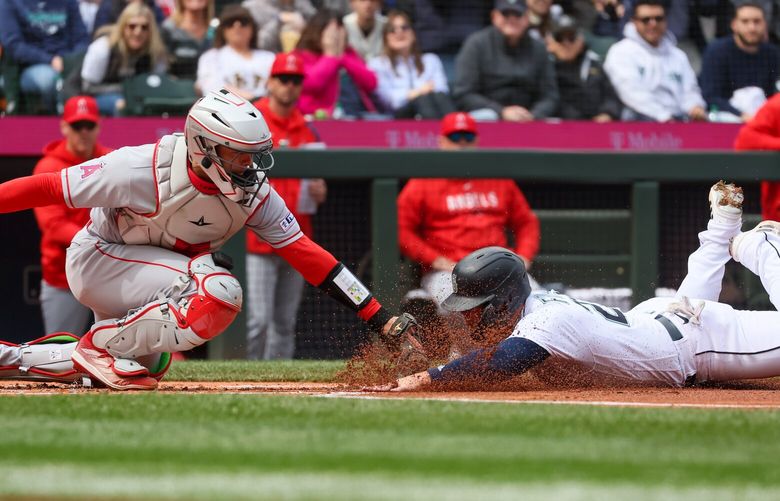 Seattle Mariners first baseman Ty France is tagged out at home by Los Angeles Angels Logan O’ Hoppe Wednesday afternoon at T-Mobile Park in Seattle, Washington on April 5, 2023.