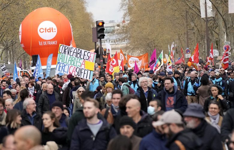 Demonstrators march during a protest Thursday, April 6, 2023 in Paris. Hundreds of thousands of people are expected to fill the streets of France Thursday for the 11th day of nationwide resistance to a government proposal to raise the retirement age from 62 to 64. The furious public reaction to the plan has cornered and weakened French President Emmanuel Macron. (AP Photo/Christophe Ena) PAR126 PAR126