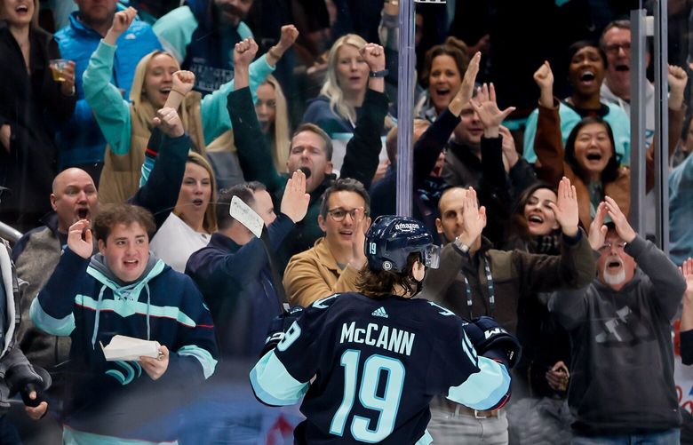 Fans cheer after Seattle Kraken left wing Jared McCann scored a short handed goal during the first period. 223406