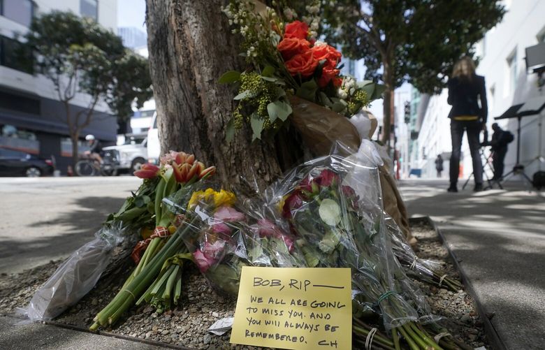 Flowers sit at a tree in front of the building where a technology executive was fatally stabbed outside of in San Francisco, Thursday, April 6, 2023. Details of how tech executive Bob Lee came to be fatally stabbed in downtown San Francisco early Tuesday were scarce as friends and family continued to mourn the man they called brilliant, kind and unlike others in the industry. (AP Photo/Jeff Chiu) CAJC107 CAJC107