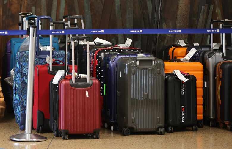 Unclaimed bags sit idle at the United baggage area at the Seattle-Tacoma International Airport on December 28, 2022. Winter storms that swept through the Pacific Northwest continue to impact travel, causing scores of flight delays and cancellations