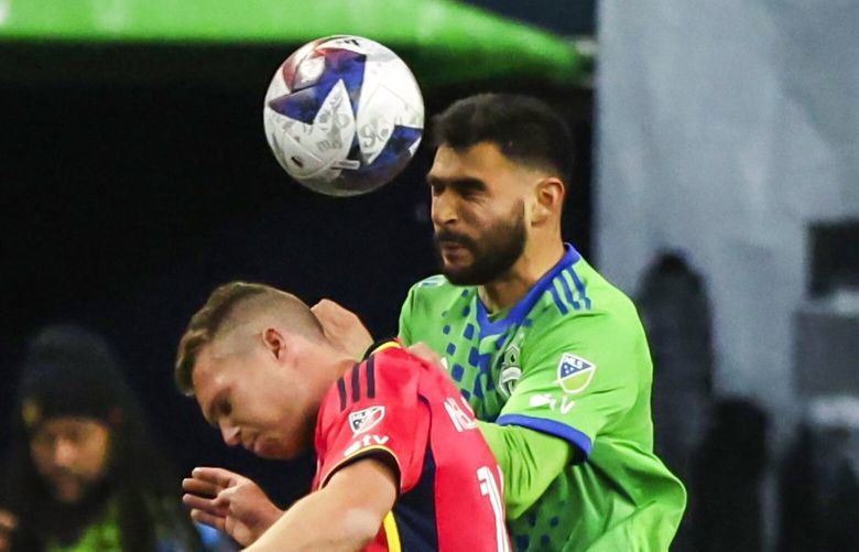 Seattle midfielder Alex Roldan heads the ball over St. Louis defender John Nelson in the first half as the Seattle Sounders FC take on St. Louis City SC Saturday April 8, 2023 at Lumen Field in Seattle. 223485