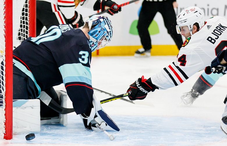 Seattle Kraken goaltender Martin Jones turns away a point blank shot by Chicago Blackhawks left wing Anders Bjork during the second period. 223484