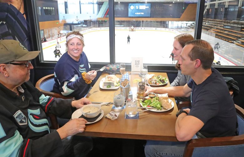 One of the best bars to watch the hockey playoffs is 32 Bar and Grill at the Northgate Kraken Community Iceplex.  There are window tables that allow a view of one of the rinks below.
From left, Mike Dettmer, his daughter Christy Dettmer, Andrea Corte and Darin Corte. 223445