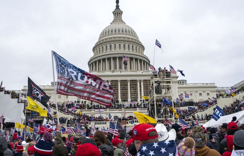 FILE – Insurrectionists loyal to President Donald Trump storm the U.S. Capitol in Washington on Jan. 6, 2021. A federal appeals court sided on Friday, April 7, 2023, with the Justice Department in a case that could have upended hundreds of charges brought in the Capitol riot investigation. (AP Photo/Jose Luis Magana, File) WX107 WX107