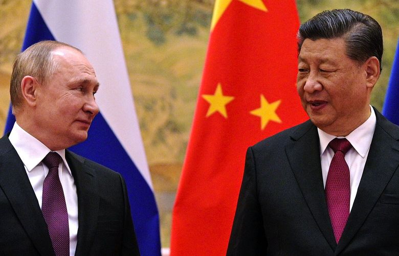 Chinese President Xi Jinping, right, and Russian President Vladimir Putin talk to each other during their meeting in Beijing, China, Friday, Feb. 4, 2022. Russian President Vladimir Putin is in Beijing for the Winter Olympics and talks with his Chinese counterpart Xi Jinping, amid soaring tensions with Ukraine. (Alexei Druzhinin, Sputnik, Kremlin Pool Photo via AP) XAZ107 XAZ107
