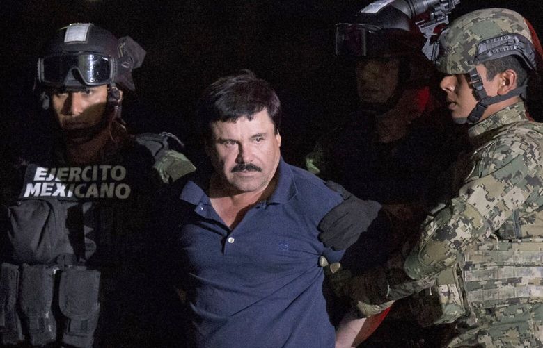 FILE – In this Jan. 8, 2016 file photo, Mexican drug lord Joaquin “El Chapo” Guzman is escorted by army soldiers  to a waiting helicopter, at a federal hangar in Mexico City, after he was recaptured from breaking out of a maximum security prison in Mexico. The Spanish-language network Telemundo says it hopes to continue its growth with a non-traditional programming strategy that will include projects based on the story of drug lord El Chapo, the life of Venezuelan leader Hugo Chavez and the late singer Jenni Rivera. (AP Photo/Rebecca Blackwell, File)
