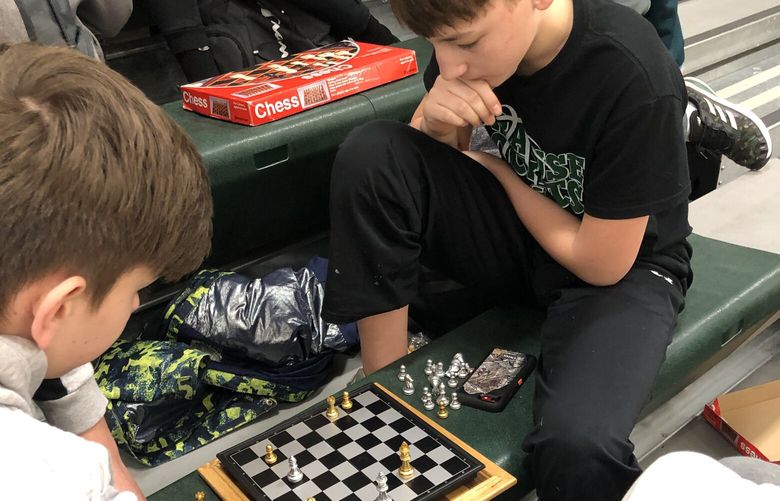 Spencer Noerrlinger, 13, right, started a chess club this year after noticing that many of his peers at his Nebraska school had become chess fans, too. MUST CREDIT: Tim Farley.
