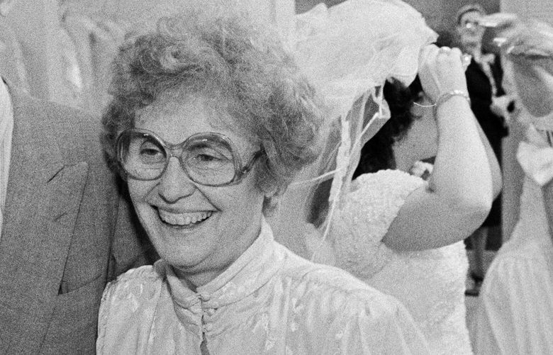 FILE — Hedda Kleinfeld Schachter with her husband, Jack, at I. Kleinfeld & Son, her Brooklyn bridal shop, which she ran like a benevolent matriarch, on March 26, 1987. Kleinfeld Schachter, who built the empire of tulle and satin known as Kleinfeld’s, the bridal superstore that for decades drew women from all over the world to the unlikely locale of Bay Ridge, Brooklyn, died on March 29, 2023 in Manhattan. She was 99. (Sara Krulwich/The New York Times) XNYT91 XNYT91