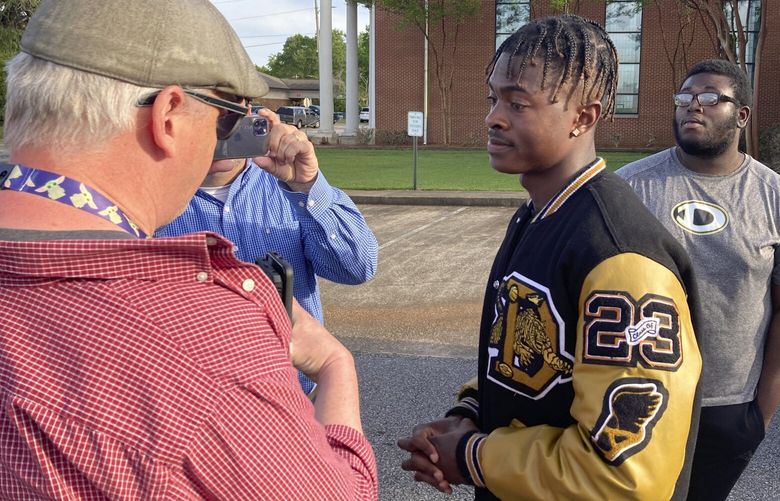 Antojuan Woody talks to reporters on Sunday, April 16, 2023, in Dadeville, Ala., about the death of Phil Dowdell, his best friend, and fellow Dadeville High School football player. Dowdell was one of several people killed in a shooting at a teenager’s birthday party in the town on Saturday, April 15. (AP Photo/Jeff Amy) RPJA712 RPJA712